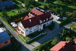 an overhead view of a large white house with a red roof at Pensjonat U Bogusi in Berezka