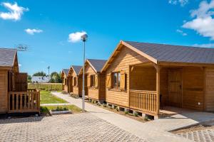 a row of wooden cabins in a row at Pirat Gąski in Gąski