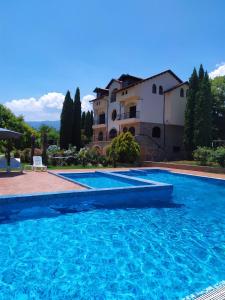 a large swimming pool in front of a house at Villa Anna in Leptokarya