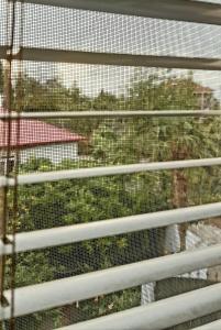 a cage with a view of a garden at TJ Guest House in Makhinjauri