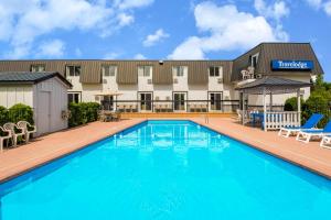 a pool in front of a hotel at Travelodge by Wyndham Gananoque in Gananoque