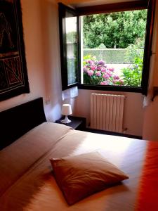 a bedroom with a bed and a large window at Casa Vacanze Santa Perpetua in Tirano