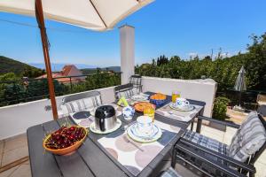 a table with a bowl of fruit on a balcony at Mountainescape- sale in Khalkiás
