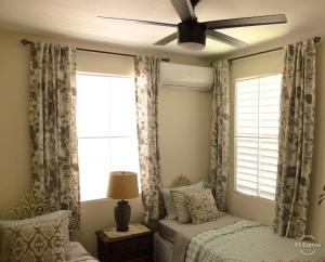 a bedroom with a bed and a ceiling fan at Isla Verde by the Beach in San Juan +51 photos