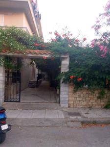 an alley with a building with flowers on it at Iridas house in Kos Town