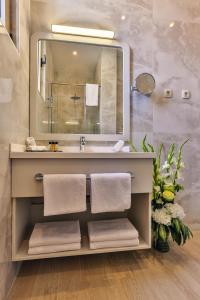 a bathroom with a sink and a mirror at Avanti Hotel & Spa in Budva