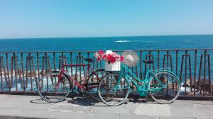 two bikes parked next to a fence near the ocean at La Gorgone Ortigia Apartments in Syracuse