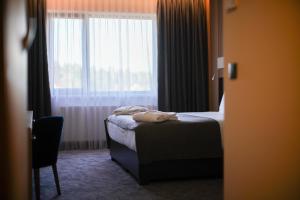 Кровать или кровати в номере AZZA Hotel