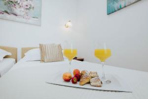 Postel nebo postele na pokoji v ubytování Hotel Vila Tina