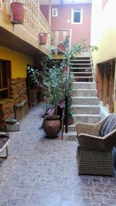 a courtyard with stairs and a potted plant in a building at B&B Chayana Wasi in Ollantaytambo