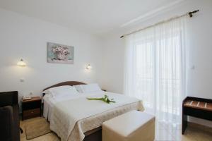Postel nebo postele na pokoji v ubytování Hotel Vila Tina