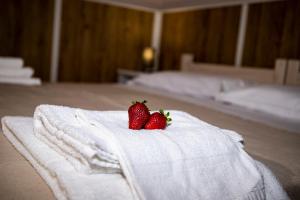 two strawberries sitting on top of a white towel at Vacanze Cassibile in Cassibile