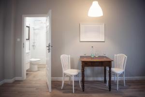 jadalnia ze stołem i białymi krzesłami w obiekcie Apartament Terra Pia w Poznaniu