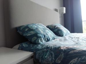 two pillows sitting on top of a bed in a bedroom at Hel Amber Apart in Hel