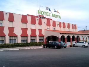 a hotel with cars parked in front of a building at HOTEL RESTAURANTE MOYA in Monesterio