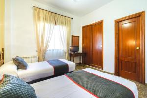 Postel nebo postele na pokoji v ubytování HOTEL RESTAURANTE MOYA