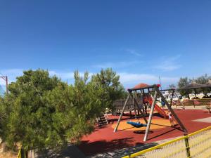 a playground with a swing set in a park at Apartment Lola in Srima