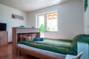 a bedroom with a bed and a window at Lavanda Apartments&Studios in Pinezici