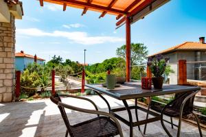 a patio with a table and chairs on a deck at Lavanda Apartments&Studios in Pinezici