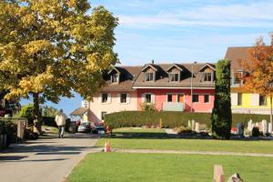 a person walking down a sidewalk in front of houses at Les Narcisses in Blonay