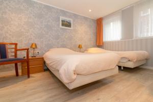 Un pat sau paturi într-o cameră la Hotel het Anker