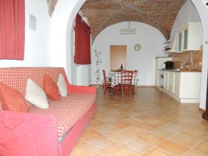 a living room with a couch and a table with chairs at Casa Vacanza Il Malandrone in Vada