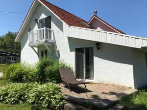 a bench sitting in front of a house at La Maison du Village, spa in Shawinigan