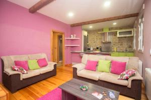 a living room with two couches and a kitchen at A Casa do Avó in Palas de Rei 