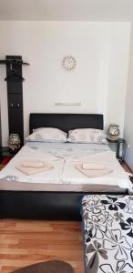 a bed in a room with a white wall at Opatija Rooms & Apartments Semić - Free Parking and Sea View in Opatija
