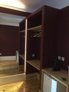 a room with a closet with a wooden floor at Pimms Home Ribeira in Porto