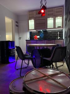 a room with a ping pong table and chairs at Resort 36 in Mikołajki
