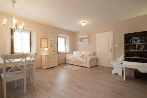 a living room with a couch and a table at Pr`Mružo apartmaji in Bohinj