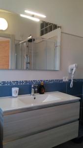 a bathroom with a sink and a mirror at Viola di Mare Rooms and Parking in Termoli
