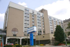 a hotel building with a sign in front of it at Wyndham Pittsburgh University Center in Pittsburgh