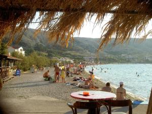 a group of people on a beach near the water at Villa Galeb Pag - at the main Beach in Pag