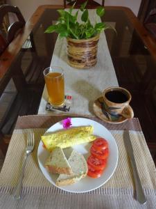 a plate of food with eggs and bread and a cup of coffee at Casa Papaki in Mérida +48 photos