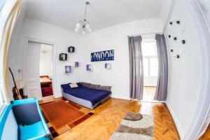 a living room with a bed and a mirror at Inner City Apartment in Debrecen