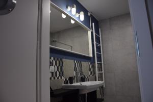 a bathroom with a sink and a mirror at VerrAri Apartaments in Łeba +31 photos
