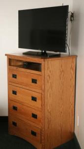 a television on top of a wooden dresser at Bozeman Inn in Bozeman