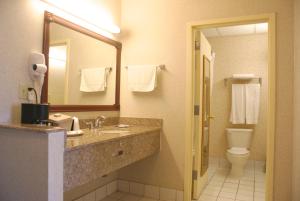 a hotel bathroom with a sink and a toilet at Raritan Hotel in Edison +16 photos
