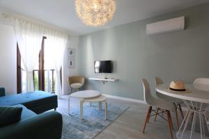 a living room with a couch and a table and chairs at Verde Suites Akyaka in Akyaka