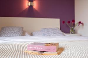 a book sitting on top of a bed at Modrý Dom in Spišské Bystré