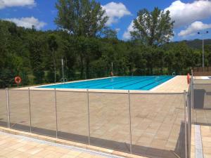 an empty swimming pool behind a fence at FINCA SALVADOR in Baralla