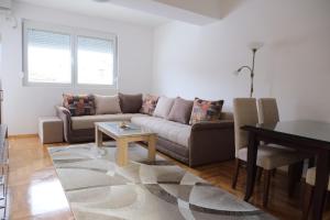 a living room with a couch and a table at Enjoy Apartments Karamach in Ohrid
