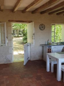a kitchen with a table and a counter top at Bois logis in Bléré