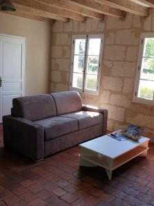 a living room with a couch and a coffee table at Bois logis in Bléré