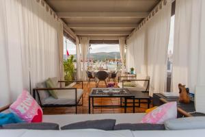 a living room with couches and a table and chairs at Studio Tironi in Trogir