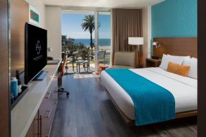 a hotel room with a bed and a view of the ocean at Shore Hotel in Los Angeles