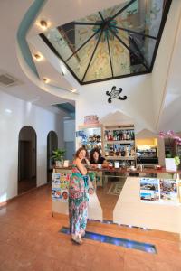 a woman standing in front of a counter in a store at Art Hotel La Perla in Bellaria-Igea Marina