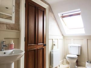 a bathroom with a sink and a toilet and a skylight at Wild Atlantic Breeze Guesthouse in Doolin